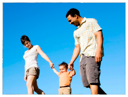 Family going for a walk with their child.